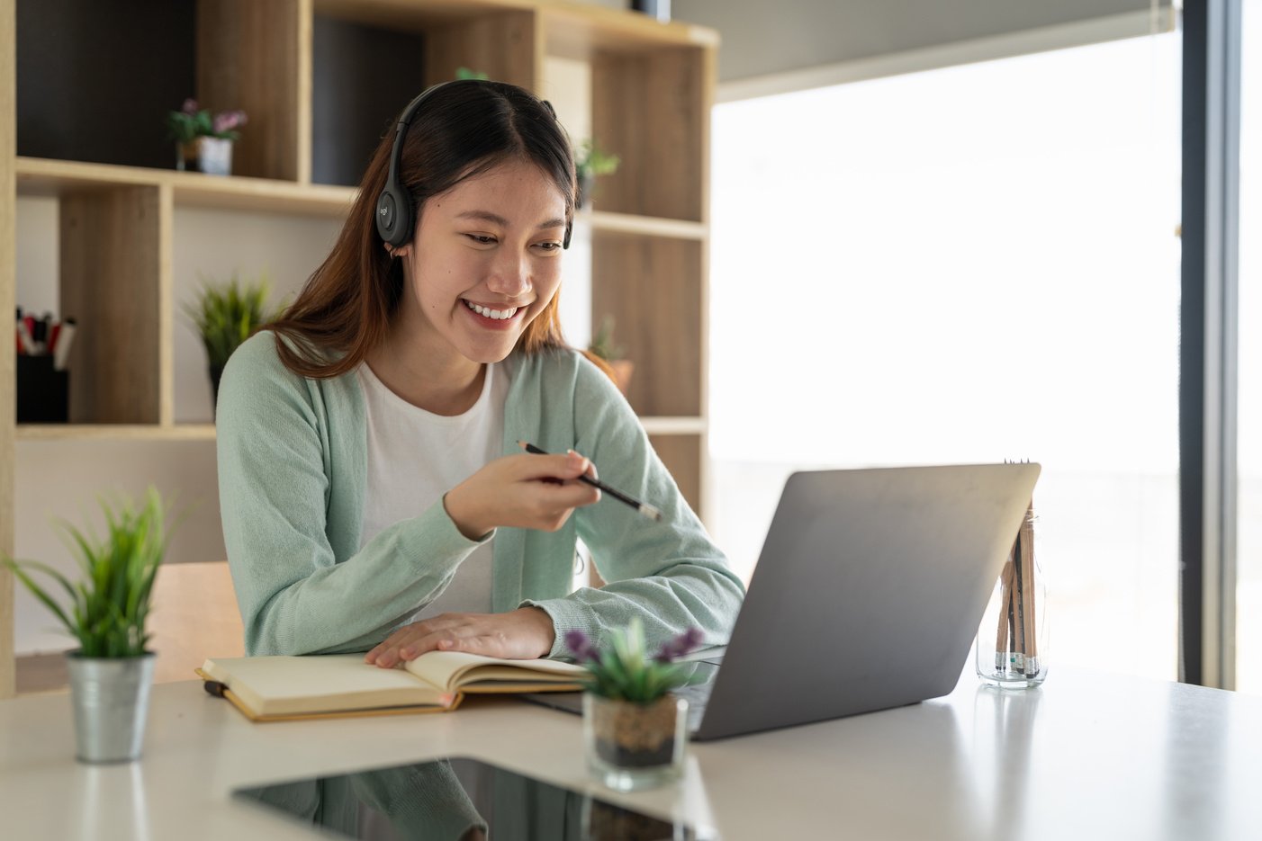 Concentrate asian gial freelancer wearing headset, communica